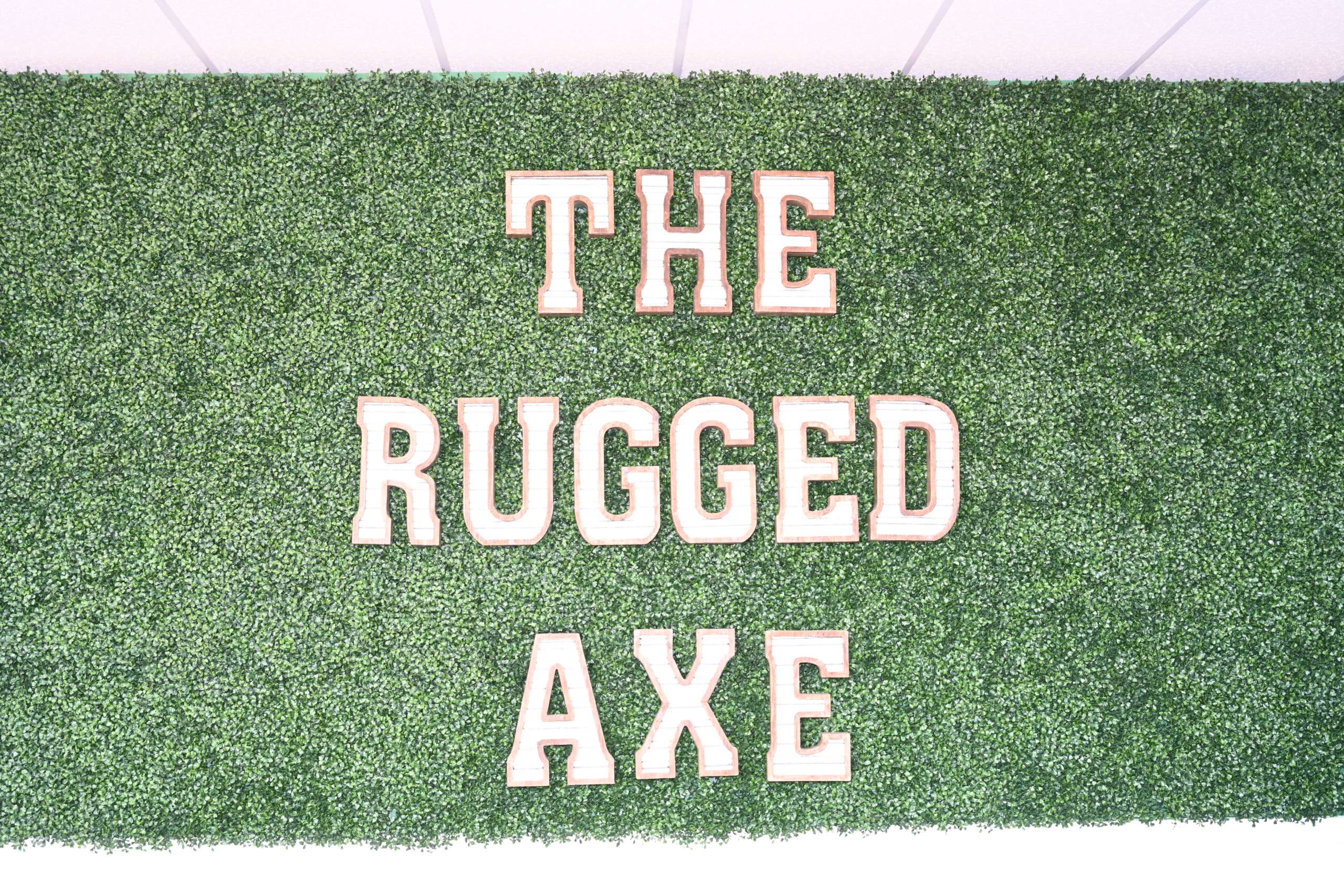 Caged axe throwing lanes with wooden targets at The Rugged Axe in Manchester NH